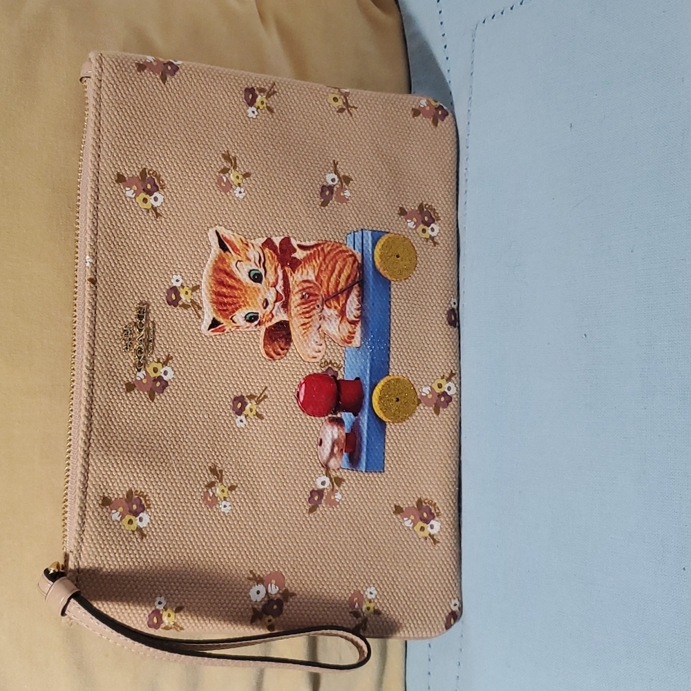 Coach brown retro toy kitten pouch.